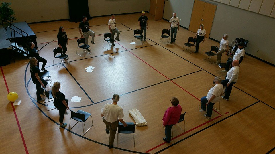 Participants participating in Physical Therapy sitting in a circle.