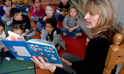Teacher reading to students in classroom.