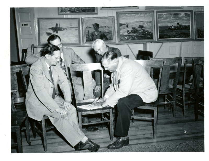 Harvey Dunn signing the letter that bequeathed his paintings to the people of South Dakota, Aug. 24, 1950