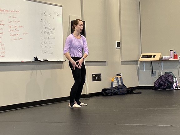 A dancer teaching choreography in the studio.