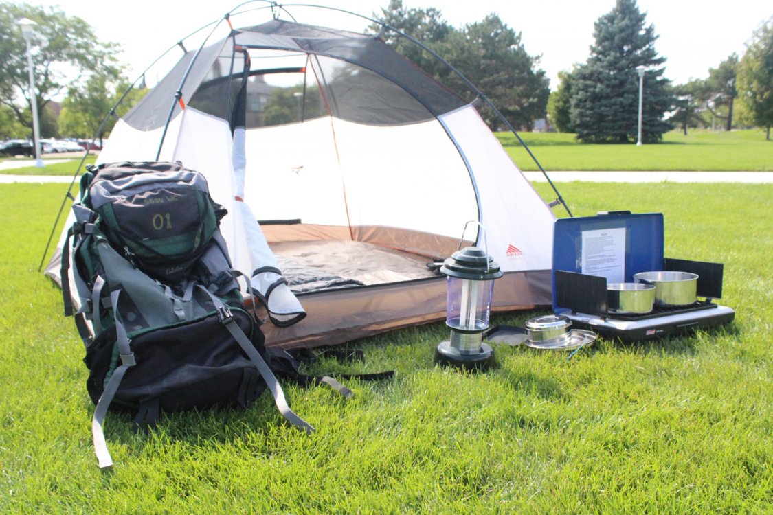 Outdoor gear rental tent, backpack, lantern, and camp stove.