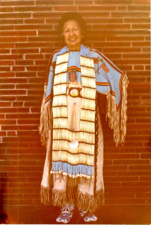 Emma Amiotte wearing an Oglala Sioux breastplate and dress