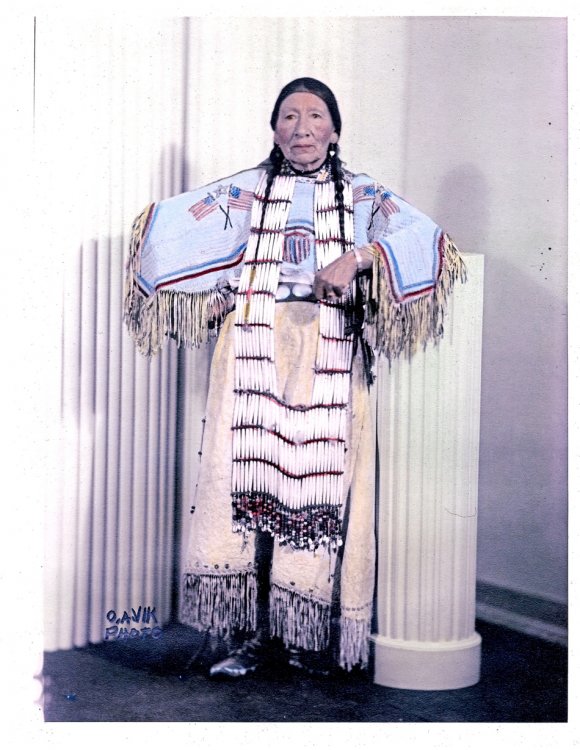 Maggie Red Bear wearing an Oglala Sioux breastplate and dress