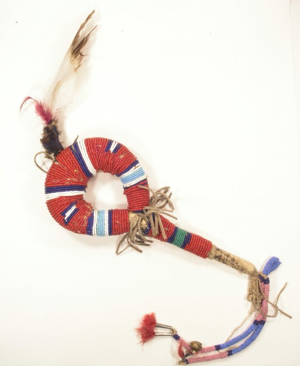 untitled (Strong Heart Society rattle) by unknown, Standing Rock Sioux, early 20th century deerskin tube attached to wooden handle, beaded, with stone rattles inside  South Dakota Art Museum, 2004.05.06. Reifel Tribal Art Collection.  Gift of Loyce R. Anderson.