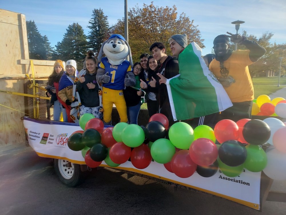 OMA students on their Hobo Day float posing with Jack, the SDSU mascot. 