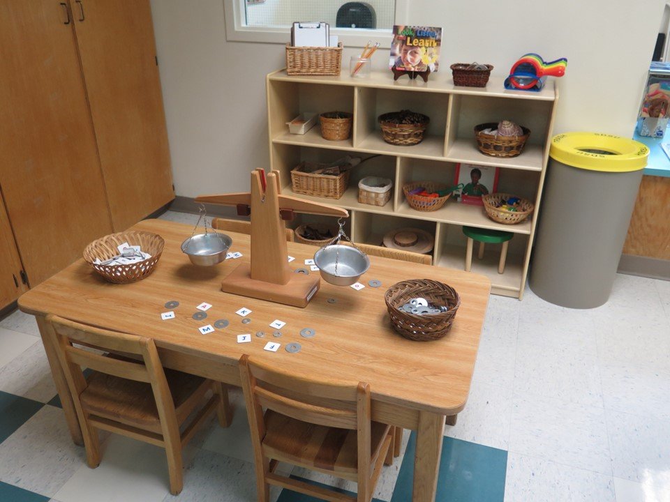 At the science area there is a balance scale with different size and weight washers as well as letter tiles.