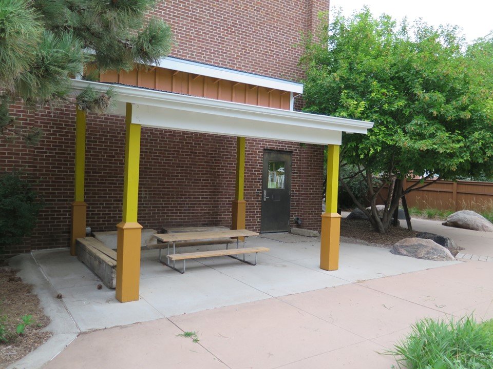 The covered outdoor space on the playground. 
