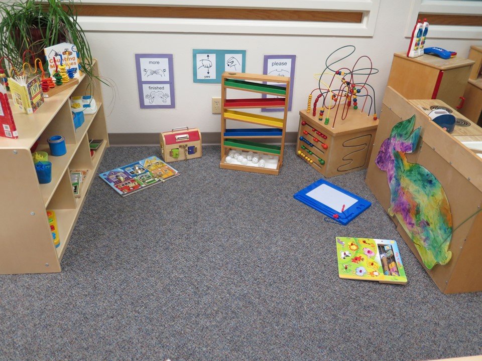 Toddler manipulative area with puzzles and fine motor experiences.