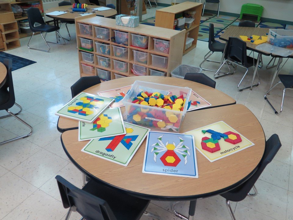 At this table there are pattern blocks and boards with different figures to create.