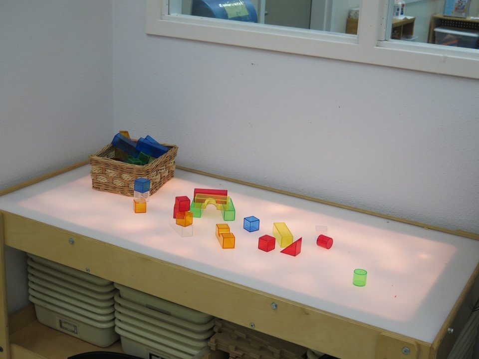 Kindergarten light table with translucent blocks on it.