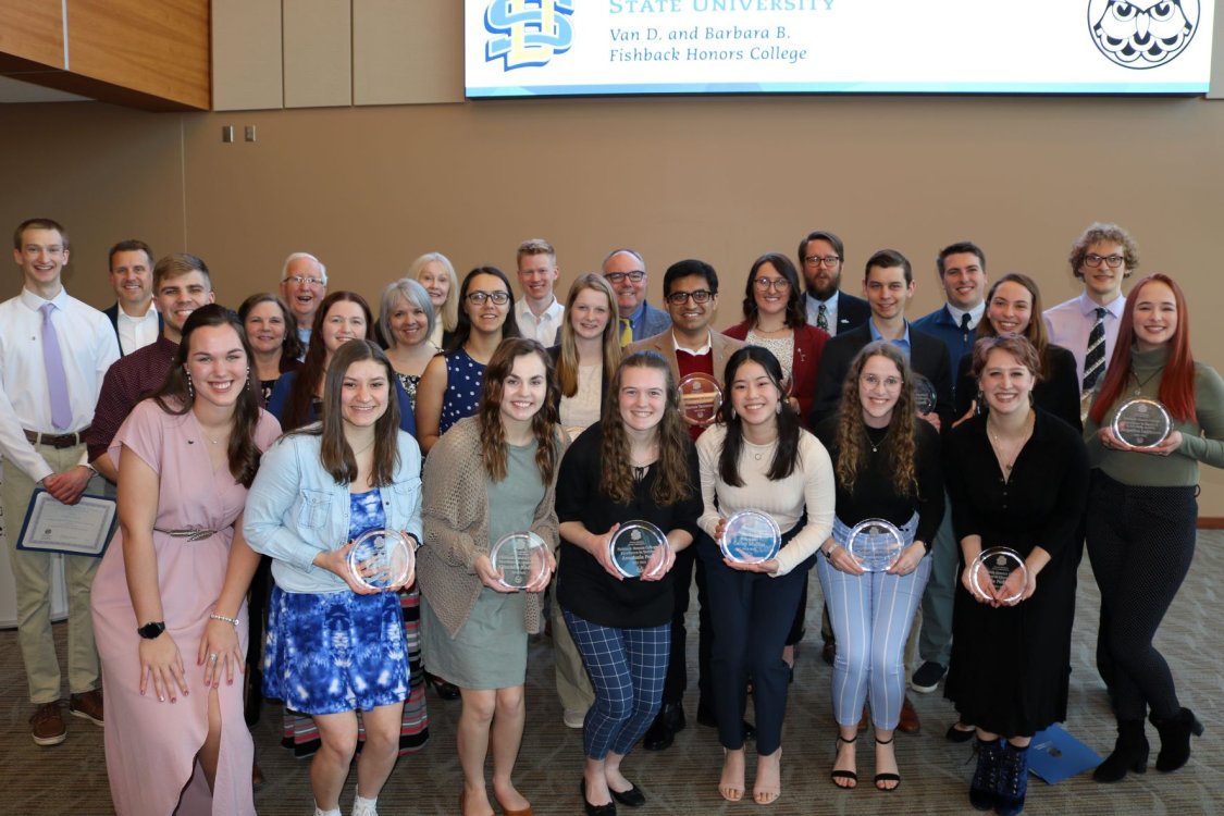 Fishback Honors College students holding their awards after Convocation