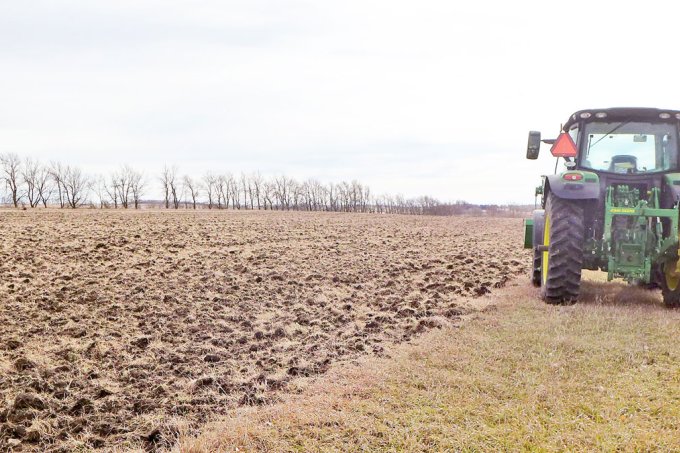 Plowed up plots of prairie at Oak Lake next to John Deere tractor