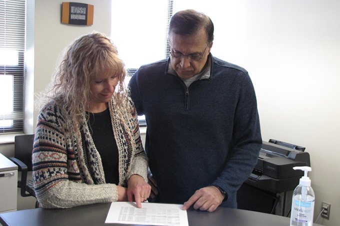 Syed Ahmed, new head of the Department of Construction and Operations Management within Lohr College of Engineering at SDSU, reviews paperwork with Pamela Rice, the department’s program assistant. He succeeds Teresa Hall, who retired in April.