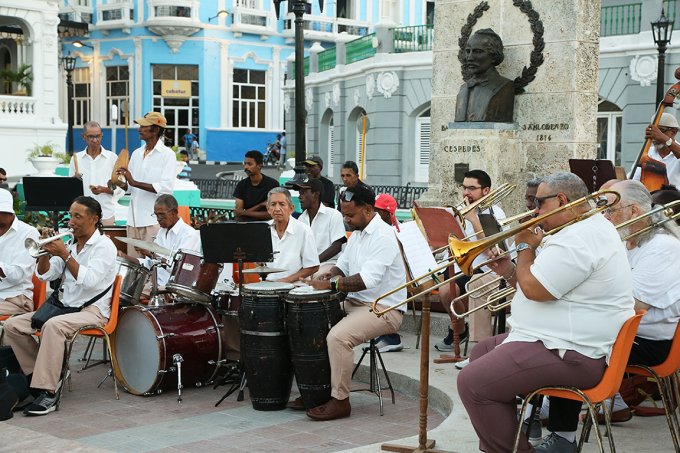 Musicians in a jazz ensemble from the United States perform in their last engagement in Cuba, which was sitting in with a community band. Bradley Snyder, instructor of low brass at South Dakota State University, is shown in the back row, beneath a Cespedes statue.