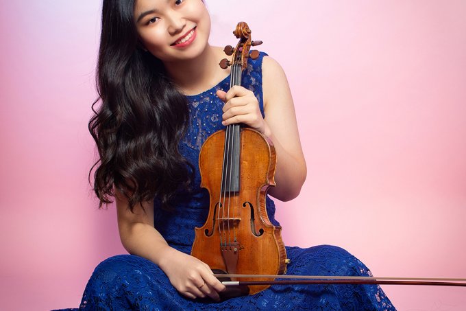 Musician SooBeen Lee holding a violin.