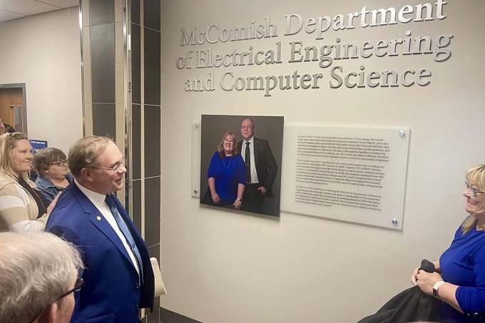 Dick and Karen McComish look on after unveiling the signage naming the new McComish Department of Electrical Engineering and Computer Science.