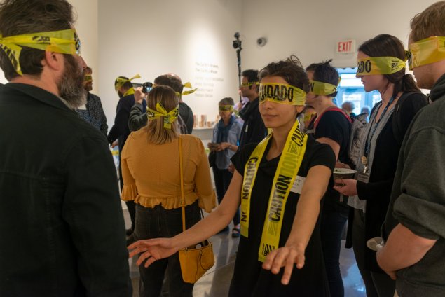 People blindfolded by police caution tape
