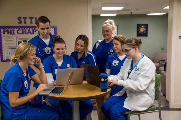 Nursing students working in the common area.