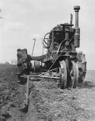 Plow guide for row crop tractors