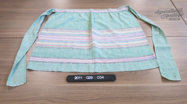 2011:029:034 Teal apron with multi-colored horizontal stripes.