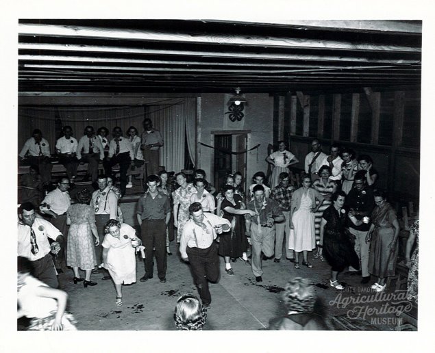 A black and white photo of a group of people dancing at Camp Lakodia in South Dakota in 1952 