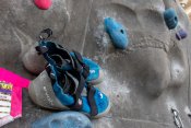 Blue climbing shoes places on a rock wall