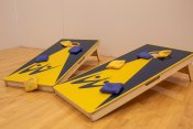 Blue and Yellow cornhole boards with 8 multi colored bean bags.