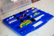 Blue tackle box with fishing gear inside