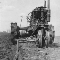 Plow guide for row crop tractors