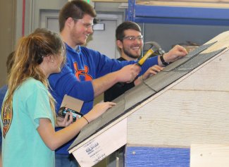 Students working on the roofing project.