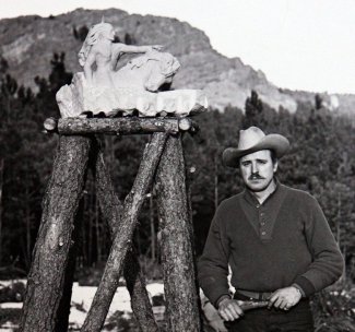 "Ziolkowski with a model of the monument in front of the hill that would be used. i"