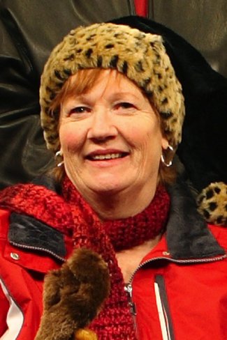 Woman in thick coat and hat smiling