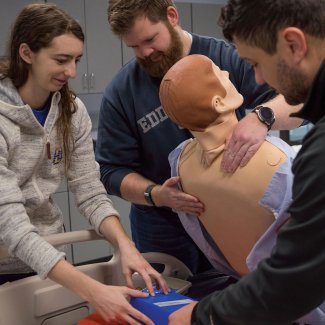 nursing students working with dummy