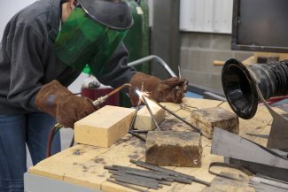 student working on sculpture