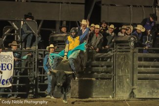 Carson Houser competing in bull riding at the Dickinson State University Rodeo in fall 2021