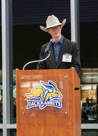 Carson Houser reciting his cowboy poetry at the 2022 Buckles & Bling Fundraiser 