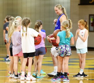 Young girls learning basketball