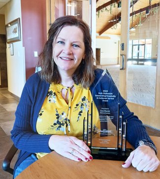 Lisa Marotz, operations director of McCrory Gardens, hold an award from the South Dakota Department of Tourism.