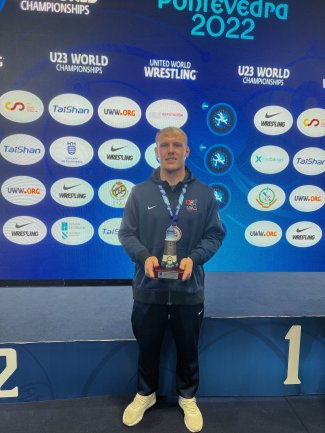 Tanner Sloan at the U23 World Championship with his award