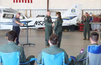 Maj. Gen. Michael Koscheski, commander of the 15th Air Force, Shaw Air Force Base, South Carolina, congratulates an Aim High Flight Academy graduate at the Brookings Regional Airport.