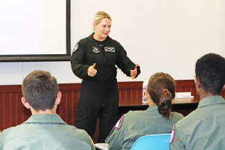Capt. Aimee "Rebel" Fiedler, a 2013 South Dakota State University grad and pilot and commander of the U.S. Air Force F-16 Viper Demo Team, speaks to Aim High Flight Academy students on the SDSU campus.