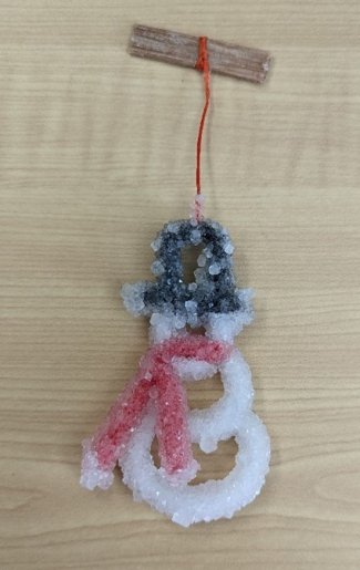 An ornament of a snowman made with borax crystals.