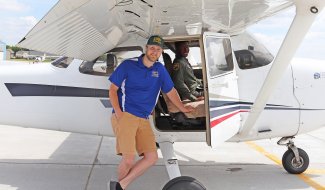 SDSU certified flight instructor Andrew Wilwerding, left, and Aim High Flight Academy student Joshua Bryant get ready for a flight in one of SDSU’s Cessna 172 Skyhawks.