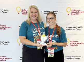 Matilyn Kerr, program adviser for university traditions, and Emma Lusk, State A Thon family relations co-chair, accept the 2023 Merchandise Award at the Dance Marathon Leadership Conference in St. Louis, Missouri, Aug. 3-6.