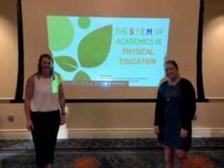 Two students presenting "The S.T.E.M. of Academics is Physical Education."