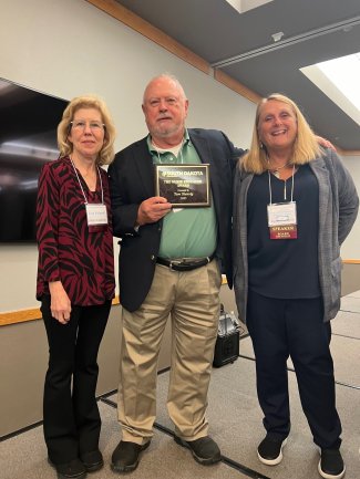 SDSU faculty member Tom Stenvig, center, is honored as Nurse Educator Award winner at the gathering of the South Dakota Nurses Association in Huron Oct. 2. She is flanked by Kay Foland, left, a retired SDSU faculty member and 2022-23 vice president of the association, and association president Deb Fischer-Clemens.