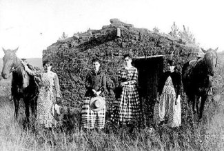 "Women homesteaders in front of their sod house"