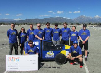 Overall winners of the Human Powered Vehicle contest in Pomona, California, March 15-17, pose with Quack Jack, the pedal-powered vehicle they designed, built and raced.  The South Dakota State University engineering students are, back row, from left, adviser Gregory Michna, Sara Broad, Evan Fick, Nicholas LaFave, Alexander Gray, Ray Munsterman, Evan Tebay, Anna Fasen and Cole Brown. In front, Lane Prather, left, and Joshua Goehring.